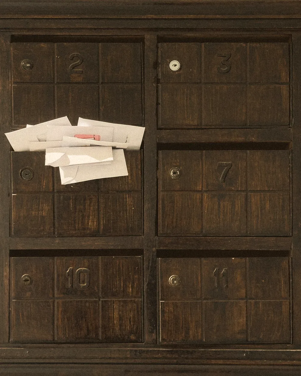 Alte Holz-Postfächer mit eingesteckten Briefen
